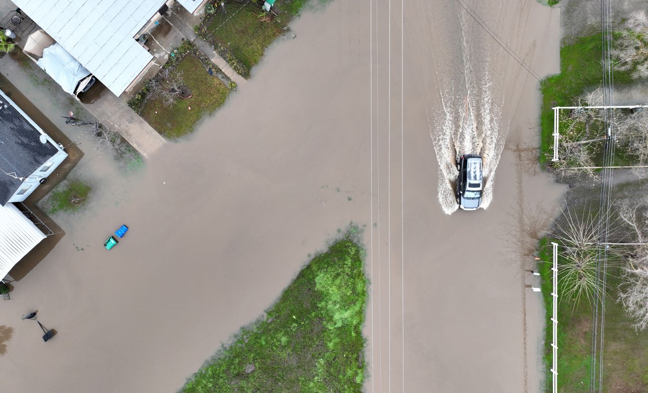 A car drives through floodwaters in Planada on January 11.