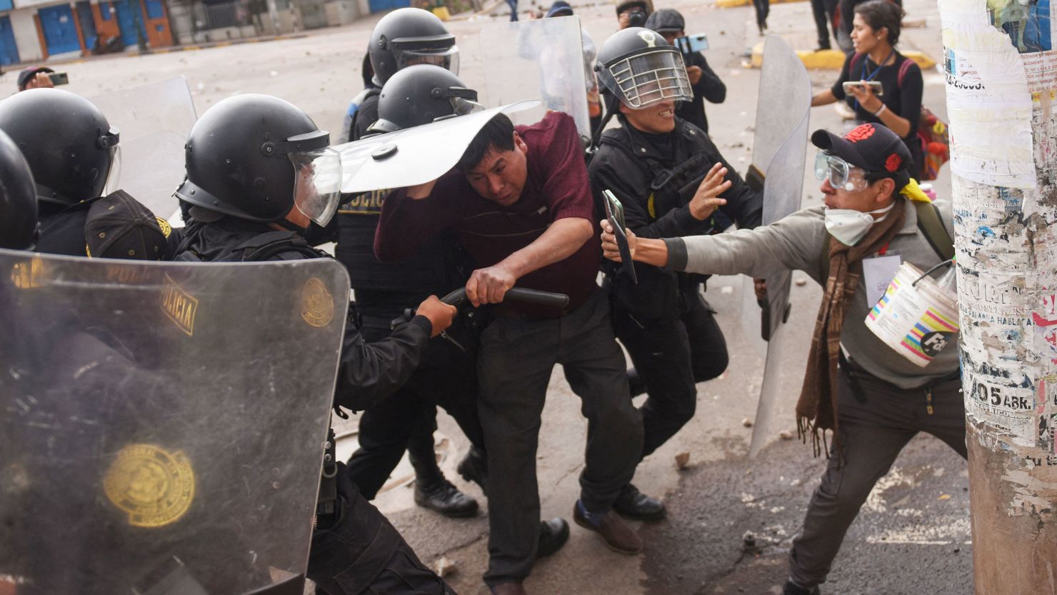Protesters clash with members of the Peruvian riot police during a demonstration in the city of Cusco on January 11, 2023. 