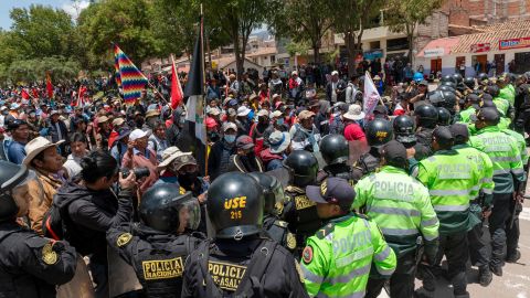 Demonstrators confront police forces as they block the way to Alejandro Velasco Astete International Airport.