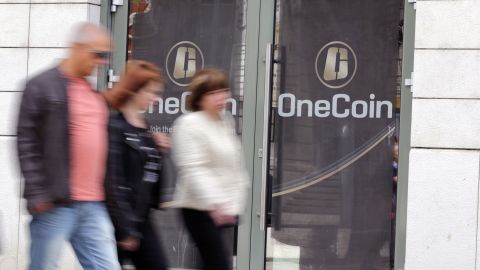 People pass by the Sofia, Bulgaria, offices of OneCoin. Federal officials say the cryptocurrency was established to defraud investors. 