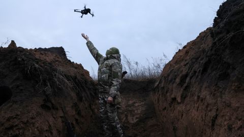 Ghost, 24, a soldier with the 58th Independent Motorized Infantry Brigade of the Ukrainian Army, catches a drone while testing it so it can be used nearby. 