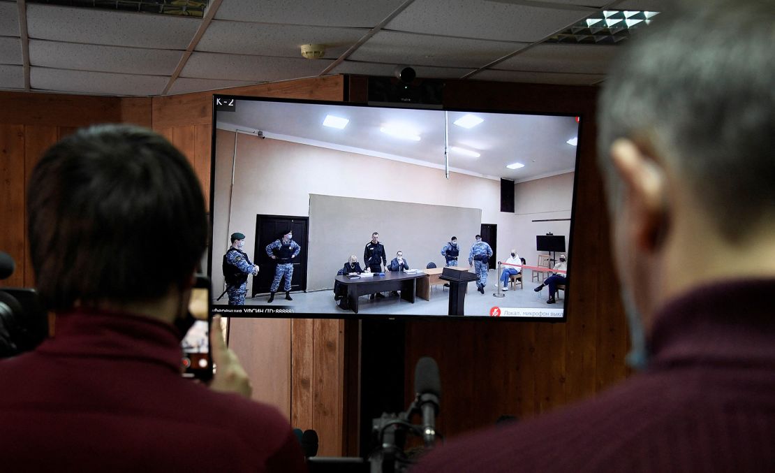 Journalists watch a live broadcast of the court hearing from the press room of the penal colony N2, on the first day of a new trial of Alexey Navalny, in the town of Pokrov on February 15, 2022.