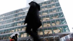 People walk by Goldman Sachs headquarters in Manhattan on December 16, 2022 in New York City. Goldman Sachs, the global investment bank, has announced that it plans on cutting up to 8% of its employees early next year as world economies and markets continue to struggle with inflation, the war in Ukraine and China's Covid policies among other issues.