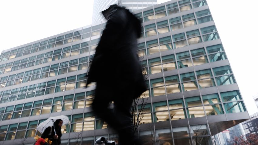 People walk by Goldman Sachs headquarters in Manhattan on December 16, 2022 in New York City. Goldman Sachs, the global investment bank, has announced that it plans on cutting up to 8% of its employees early next year as world economies and markets continue to struggle with inflation, the war in Ukraine and China's Covid policies among other issues.  