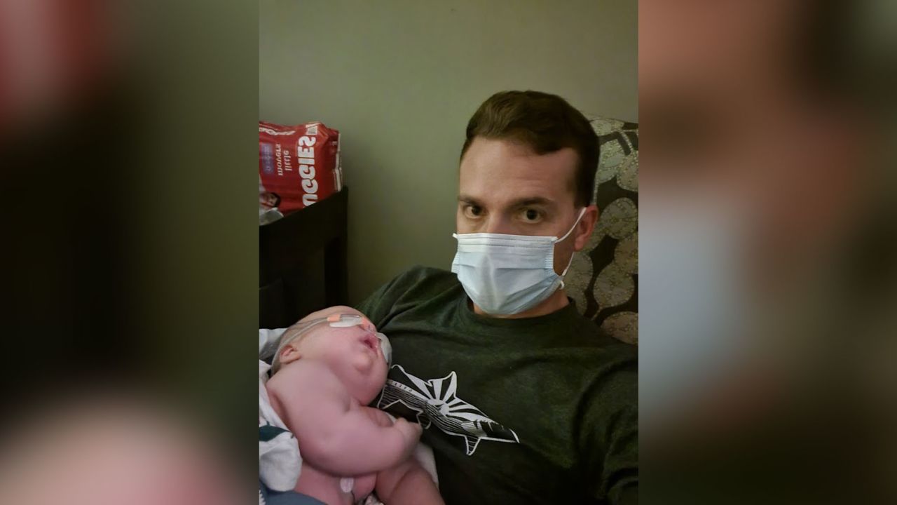 Jason Hecht holds his baby, Leon, at a hospital just hours before he was intubated.