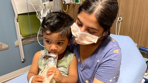 Rahman's wife, Tazima Nur, holds their son, Aarish, while he was sick in the ER.
 