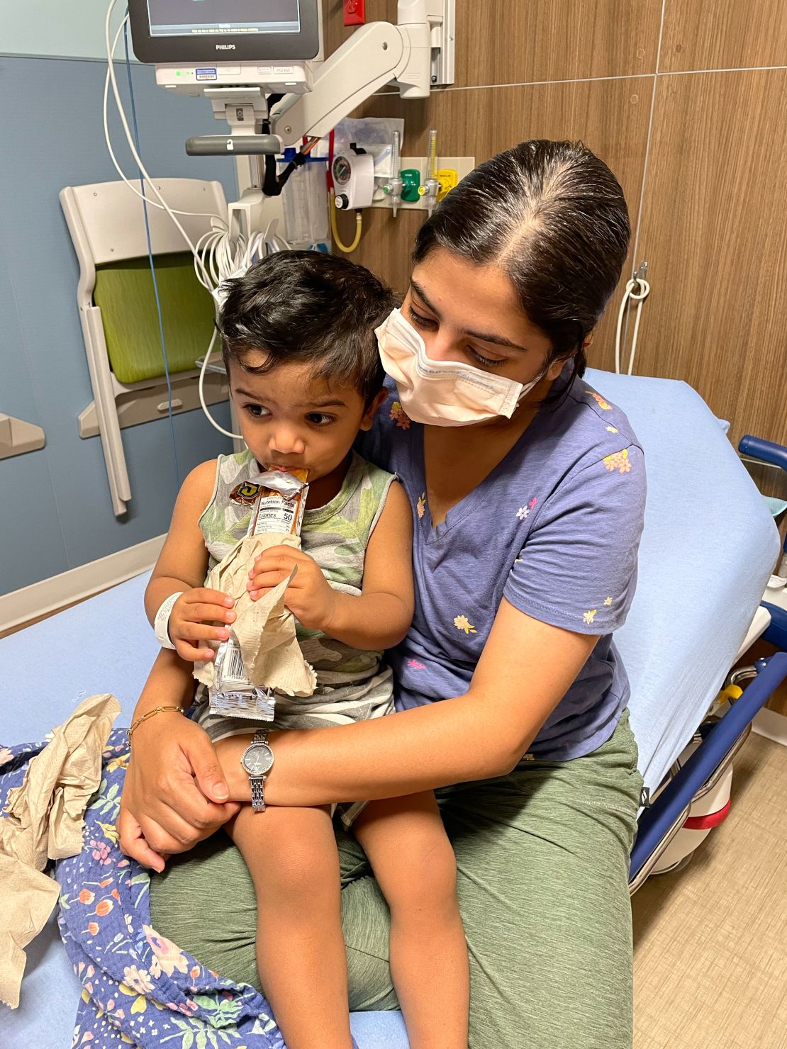 Rahman's wife, Tazima Nur, holds their son, Aarish, while he was sick in the ER.
 