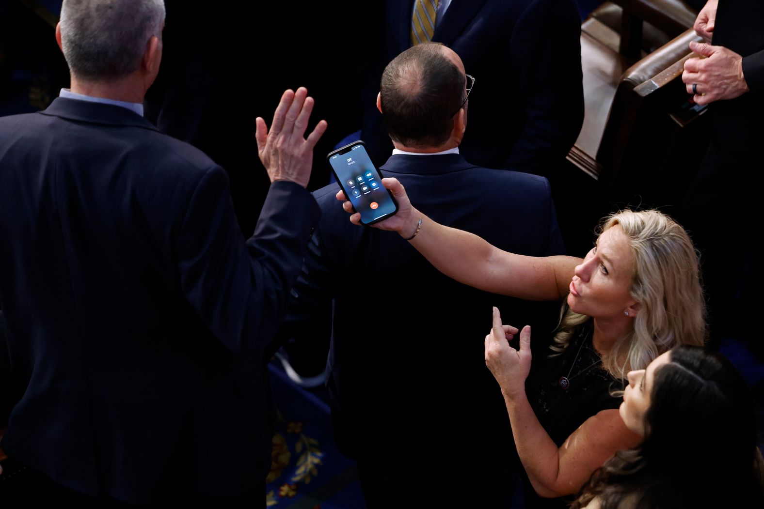US Rep. Marjorie Taylor Greene tries to hand a phone to Rep. Matt Rosendale during the frantic final House speakership votes on Saturday, January 7. The "DT" on the phone <a href="index.php?page=&url=https%3A%2F%2Fwww.cnn.com%2Fvideos%2Fpolitics%2F2023%2F01%2F09%2Fmarjorie-taylor-greene-trump-call-kevin-mccarthy-speaker-vote-ip-vpx.cnn" target="_blank">was former President Donald Trump</a>.