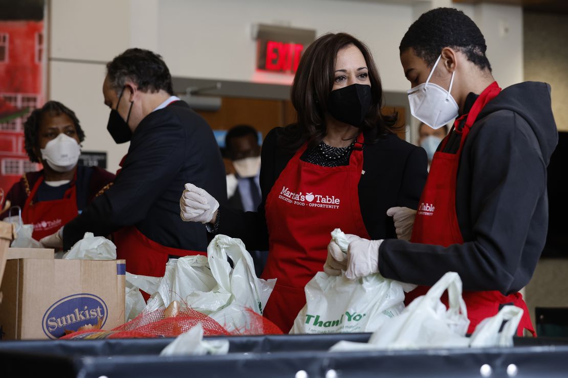 Vice President Kamala Harris (2nd L) talks with volunteers as they fill bags with food at Martha's Table, a community based education, health and family services organization, during Martin Luther King Jr. Day on January 17, 2022 in Washington, DC. 