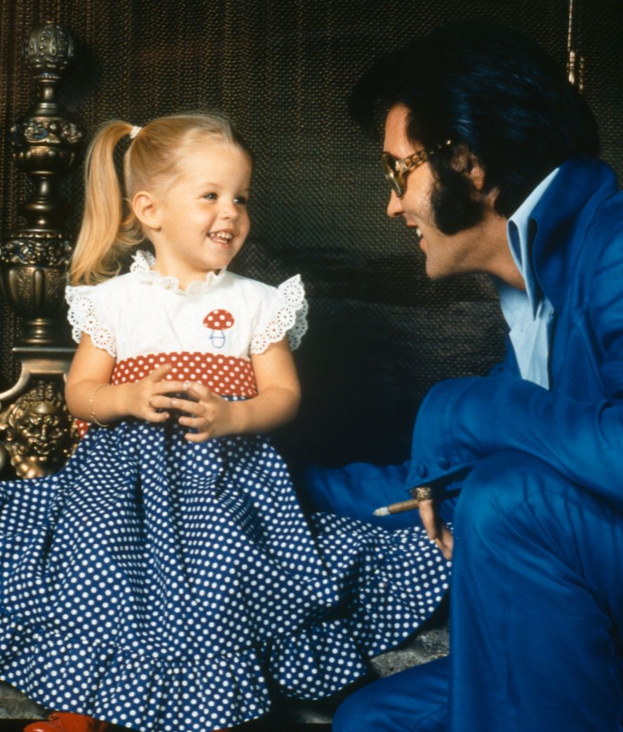 Lisa Marie Presley takes a picture with her dad in 1973. Her parents separated in 1972 when she was just 4 years old.