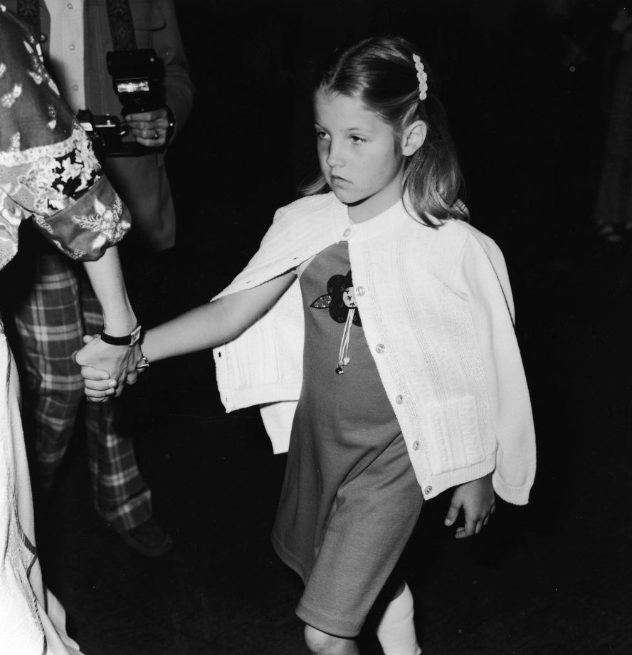 Presley attends a benefit for a mental health center in Los Angeles in March 1977. Her father died later that year. She was 9.