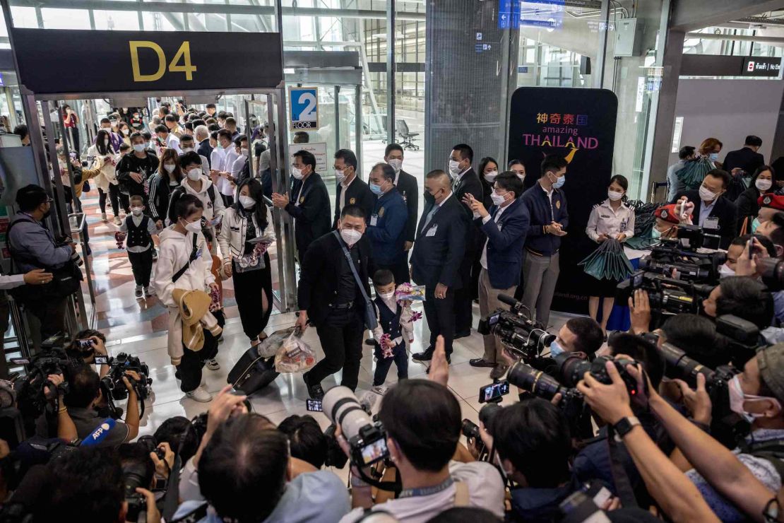 Members of the media record travellers from a Xiamen Airlines flight arriving at Suvarnabhumi Airport in Bangkok on January 9, 2023, as China removed Covid-19 travel restrictions. - China lifted quarantine requirements for inbound travellers on Sunday, ending almost three years of self-imposed isolation even as the country battles a surge in Covid cases. (Photo by Jack TAYLOR / AFP) (Photo by JACK TAYLOR/AFP via Getty Images)