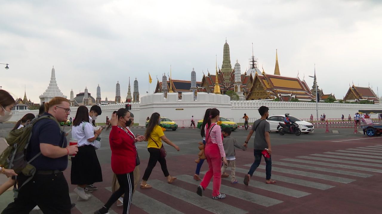 Tourists crossing a street to the Grand Palace in Bangkok on Jan. 10, 2023.
