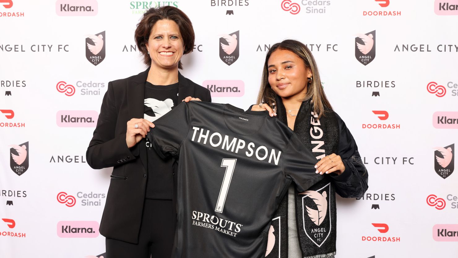 Alyssa Thompson poses with Angel City FC president Julie Uhrman having been selected with the first overall draft pick.