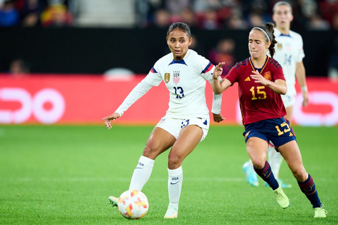 Thompson duels for the ball with Spain's Maite Oroz during a friendly at El Sadar Stadium on October 11, 2022.
