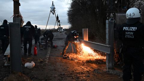 Police dismantle a barricade.  Germany plans to destroy this village for a coal mine. Thousands are gathering to stop it 230113124017 07 lutzerath germany coal mine climate intl restricted