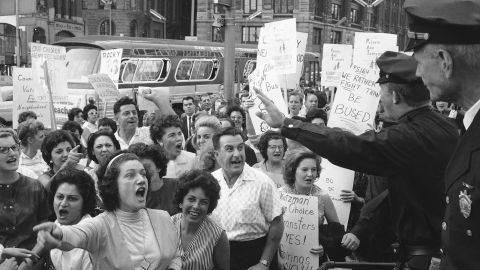 Demonstrators shout at policemen outside City Hall on Sept. 24, 1964, as they protest a busing program aimed at increasing racial balance in New York City schools.