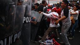 TOPSHOT - Protestors clash with the police during a demonstration against the government of Peruvian President Dina Boluarte in Lima on January 4, 2023. - Political upheaval has roiled Peru in the last weeks. Then-president Pedro Castillo on December 7 sought to dissolve Congress and rule by decree, only to be ousted and thrown in jail. Castillo was replaced by his vice president, Dina Boluarte. But Boluarte has faced a wave of often violent demonstrations calling for Castillo to be returned to power. (Photo by ERNESTO BENAVIDES / AFP) (Photo by ERNESTO BENAVIDES/AFP via Getty Images)