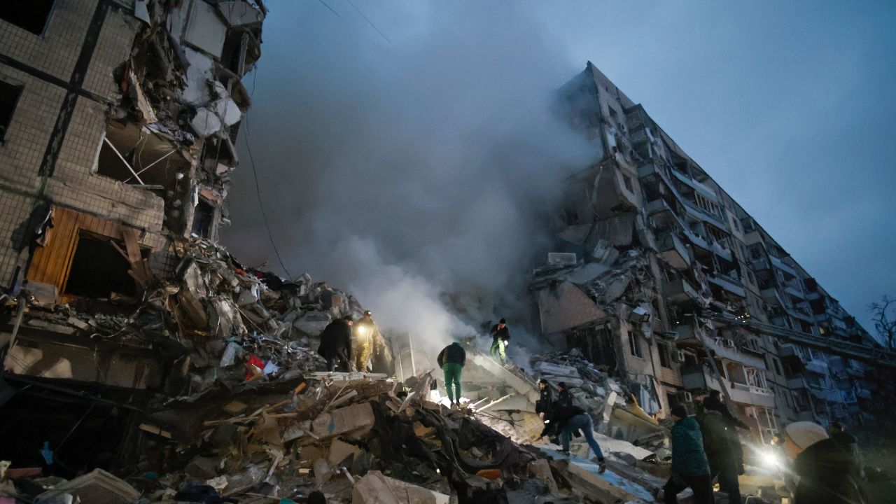 Local residents clear the rubble after a Russian rocket hit a multistory building leaving many people under debris in Dnipro, Ukraine, Saturday, Jan. 14, 2023. (AP Photo/Roman Chop)