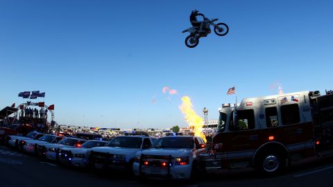 Motorcycle daredevil Robbie Knievel jumps a line of police cars, ambulances and a fire truck spanning 200 feet in his 