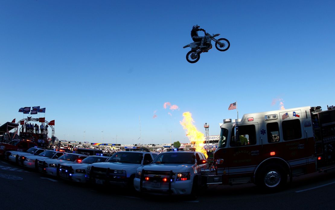 Motorcycle daredevil Robbie Knievel jumps a line of police cars, ambulances and a fire truck spanning 200 feet in his "Above the Law" jump prior to the IZOD IndyCar Series Firestone 550k at Texas Motor Speedway June 5, 2010 in Fort Worth, Texas.