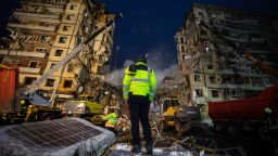 DNIPRO, UKRAINE - JANUARY 15: Rescuer stands on concrete block while firefighters are conducting search and rescue operations at residential building hit by a missile on January 15, 2023 in Dnipro, Ukraine. On January 14, Russia launched a new massive attack on Ukrainian cities. In Dnipro, one of the Х-22 cruise missiles hit a nine-story residential building, completely destroying one of the sections from top to bottom floors. The number of dead has increased to 21 people, with rescue work continuing. (Photo by Yevhenii Zavhorodnii/Global Images Ukraine via Getty Images)
