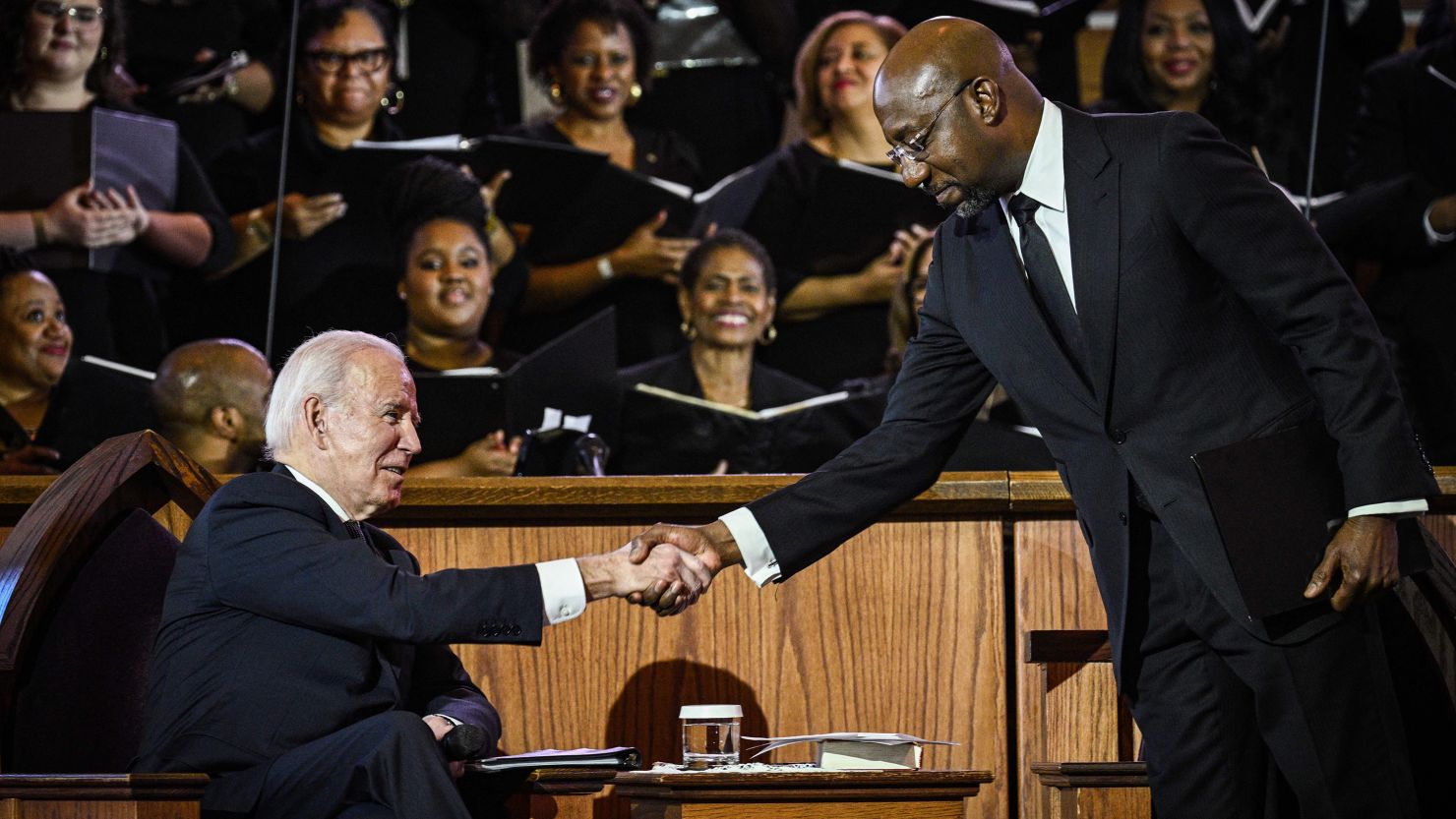 Sen. Raphael Warnock (D-Georgia), the pastor at Ebenezer Baptist Church, greets President Joe Biden during a worship service in Atlanta on January 15, 2023. 