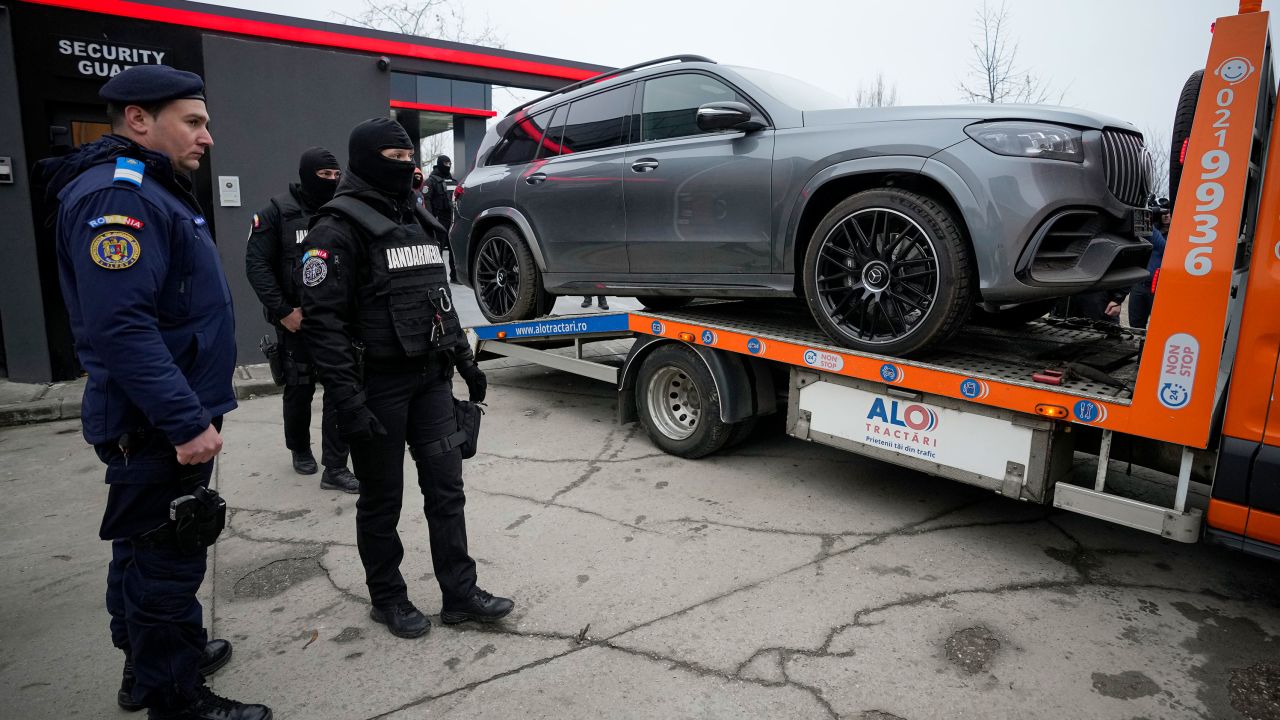 Gendarmes look as a luxury vehicle which was seized in a case against media influencer Andrew Tate, is towed away, on the outskirts of Bucharest, Romania, Saturday, Jan. 14 2023.