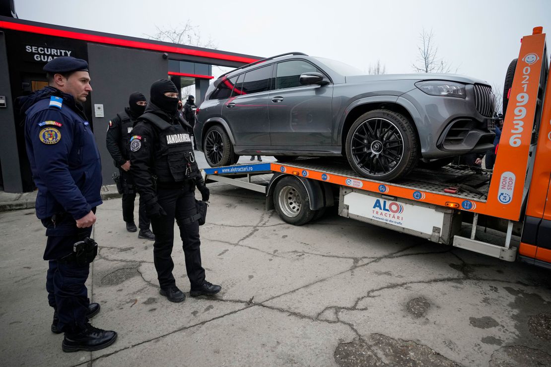 A luxury vehicle, seized in the case against Tate, is towed away on the outskirts of Bucharest, Romania, in mid-January.
