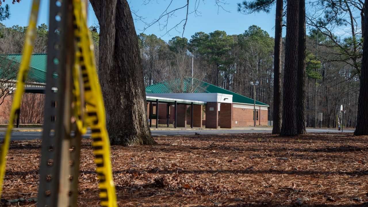 Police tape hangs from a sign post outside Richneck Elementary School following a shooting on January 7, 2023 in Newport News, Virginia. 