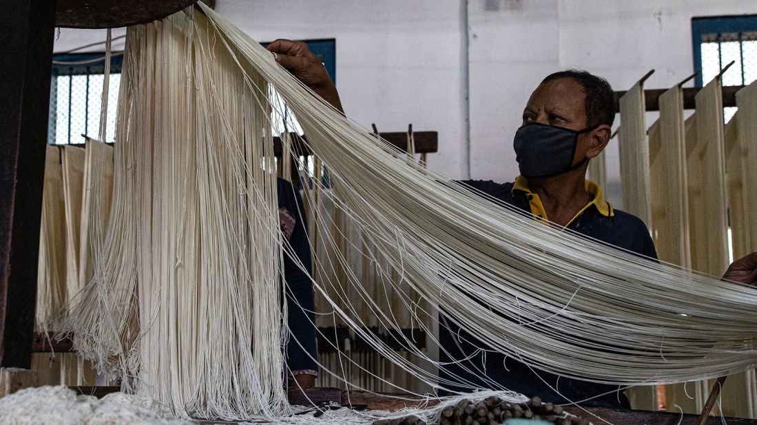 <strong>A global treat: </strong>A worker takes noodles out from slicing machines at an Indonesian factory. Longevity noodles are eaten in other Asian countries that celebrate Lunar New Year, including Vietnam, South Korea, Singapore and Malaysia.