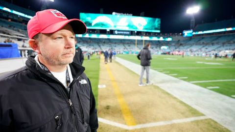 Dr.  Justin Deaton, NFL airway management physician, wears a red hat on the sideline of the Jacksonville Jaguars-Los Angeles Chargers game on Saturday.