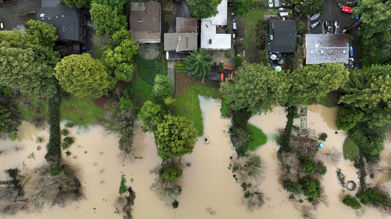 Floodwater from the Russian River approaches homes following a chain of winter storms, in Guerneville, California, January 15, 2023. 