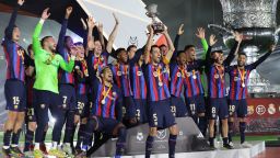 Barcelona's players celebrate on the podium after winning the Spanish Super Cup final football match between Real Madrid CF and FC Barcelona at the King Fahd International Stadium in Riyadh, Saudi Arabia, on January 15, 2023. (Photo by Giuseppe CACACE / AFP) (Photo by GIUSEPPE CACACE/AFP via Getty Images)