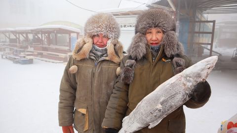 Fish vendors Marina Krivolutskaya and Marianna Ugai pose for a picture at an open-air market on a frosty day in Yakutsk, Russia, January 15, 2023. 