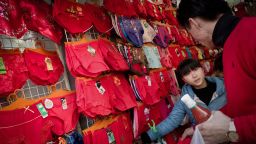 A Chinese chooses red underwear displayed in a shop on the first day of the Chinese Lunar New Year in Shanghai on February 3, 2011.  In China, the wearing of red and purple garments is a commonly believed to bring good luck.  AFP PHOTO / Philippe Lopez (Photo credit should read PHILIPPE LOPEZ/AFP via Getty Images)