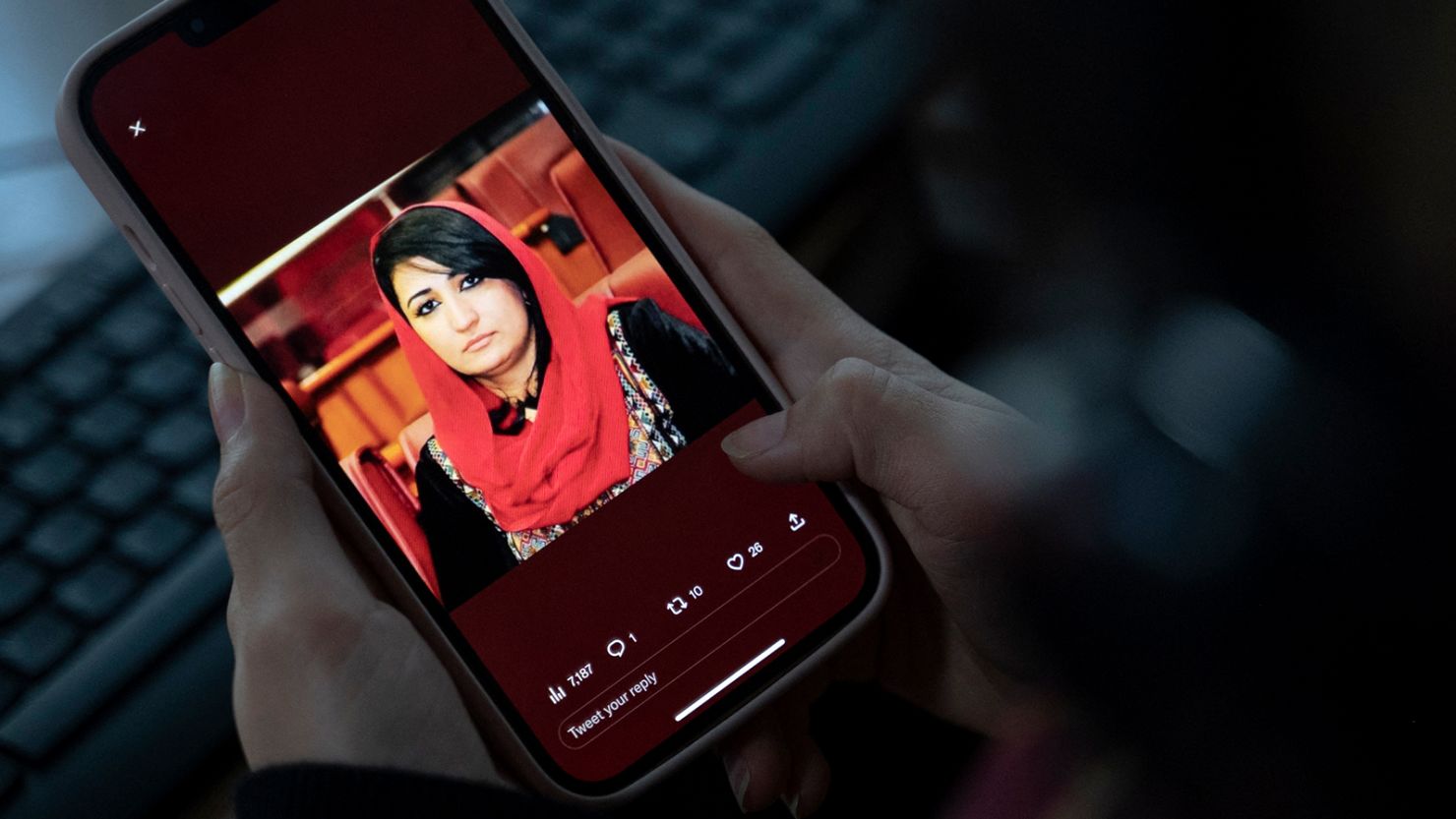A woman looks at a picture of former Afghan lawmaker Mursal Nabizada on her mobile phone, who was shot dead by gunmen at her house in Kabul on January 15, 2023. 