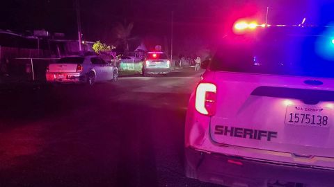 In this image released by Tulare County Sheriff's Office, detectives investigate a shooting in Goshen, California, early morning Monday.