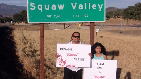 Roman Rain Tree and his daughter stand under a sign in what was formerly Sq--- Valley, California, and has now been renamed Yokuts Valley to remove the slur.