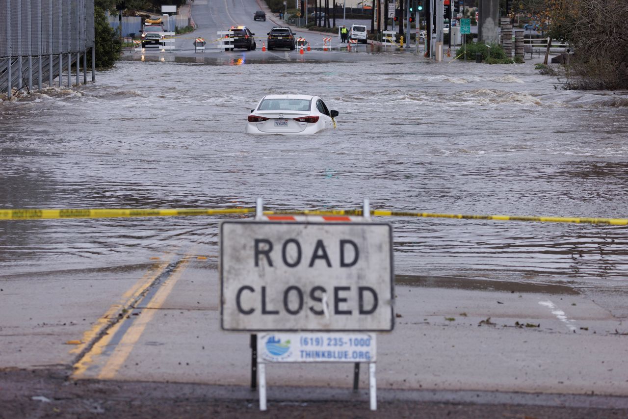 An abandoned car is trapped on a flooded street in San Diego on January 16.