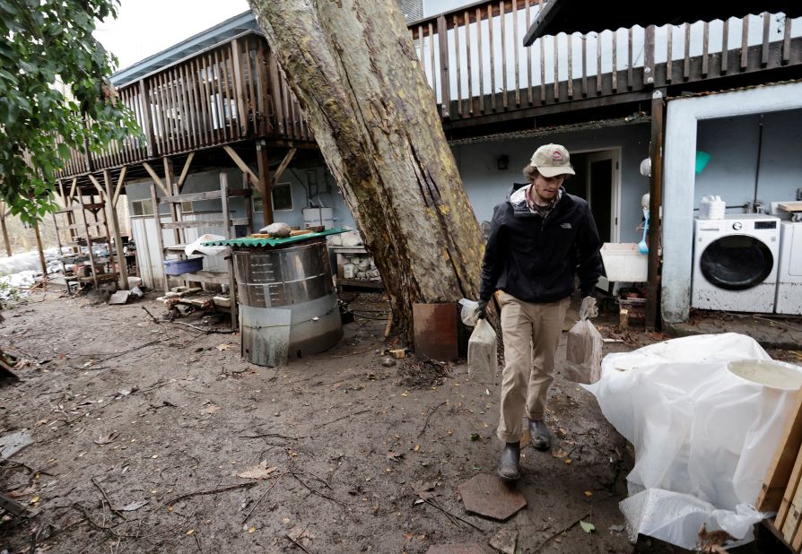 Joey Klien salvages items from his house on January 16 after part of it was flooded in Carmel Valley.