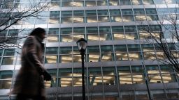People walk by Goldman Sachs headquarters in Manhattan on December 16, 2022 in New York City. 
