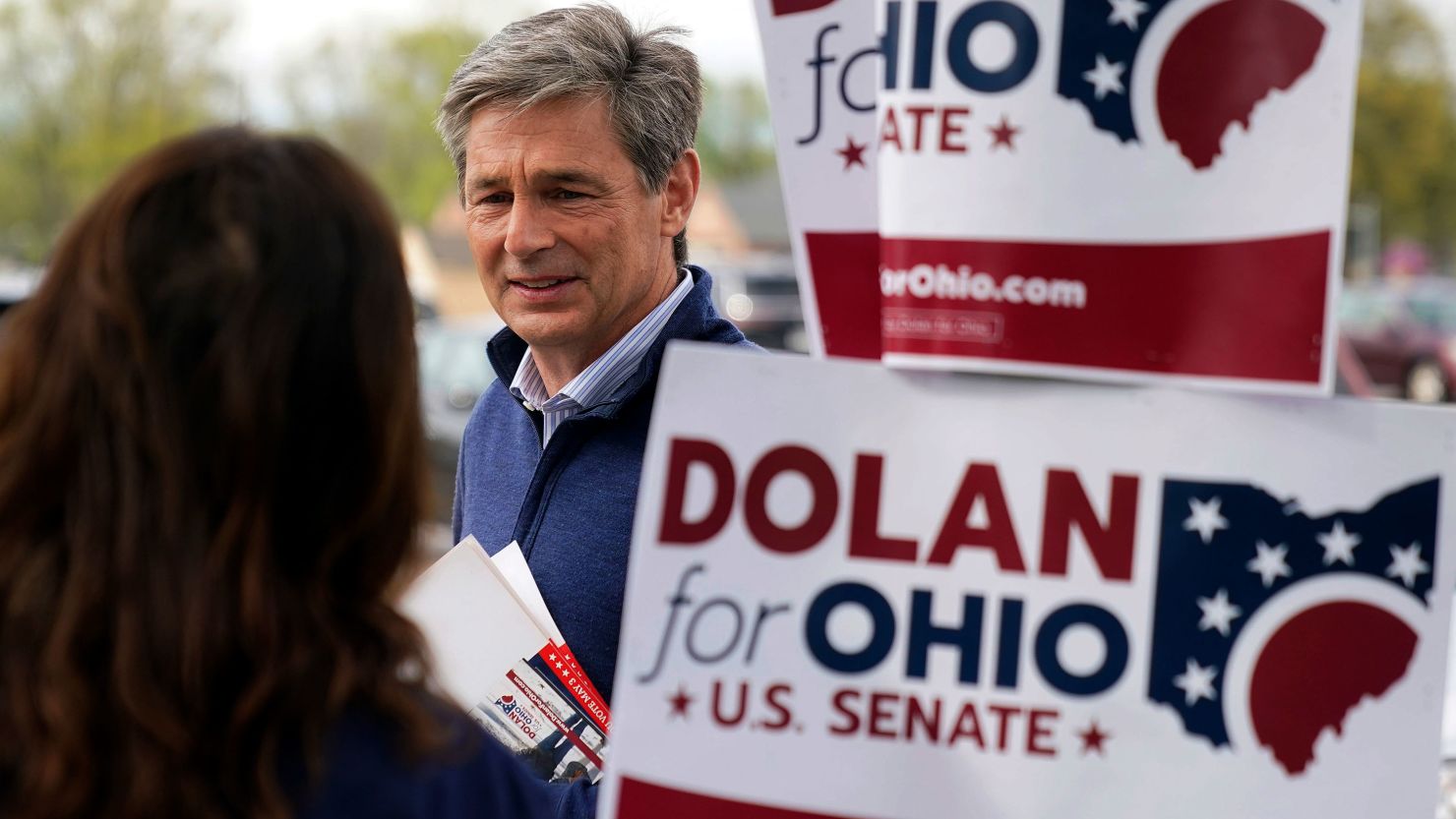 Republican US Senate candidate Matt Dolan visits with a campaign worker outside a polling place at the Parma Heights Baptist Church in Parma Heights, Ohio, on Tuesday, May 3, 2022.