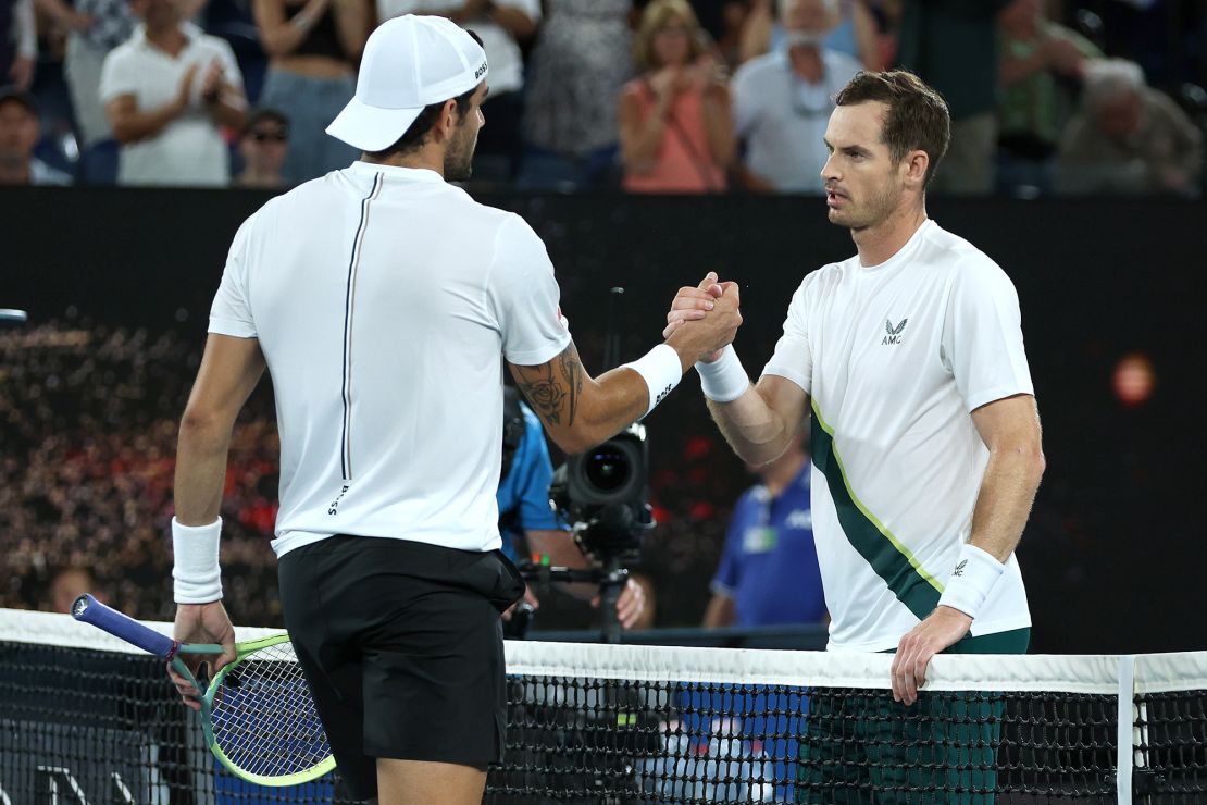 Murray shakes hands with Berrettini after winning their first round singles match.