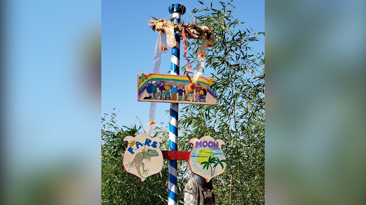Rudi and Elke have this maypole in their backyard. It's topped with an illustration of their loved ones, including Beth and Jennifer.