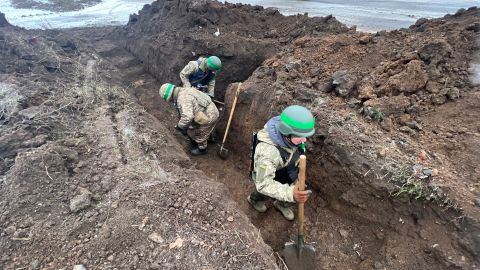 Ukrainian soldiers digging trenches in Bakhmut.