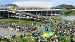 TOPSHOT - Supporters of Brazilian former President Jair Bolsonaro hold a demonstration at the Esplanada dos Ministerios in Brasilia on January 8, 2023. - Hundreds of supporters of Brazil's far-right ex-president Jair Bolsonaro broke through police barricades and stormed into Congress, the presidential palace and the Supreme Court Sunday, in a dramatic protest against President Luiz Inacio Lula da Silva's inauguration last week. (Photo by EVARISTO SA / AFP) (Photo by EVARISTO SA/AFP via Getty Images)