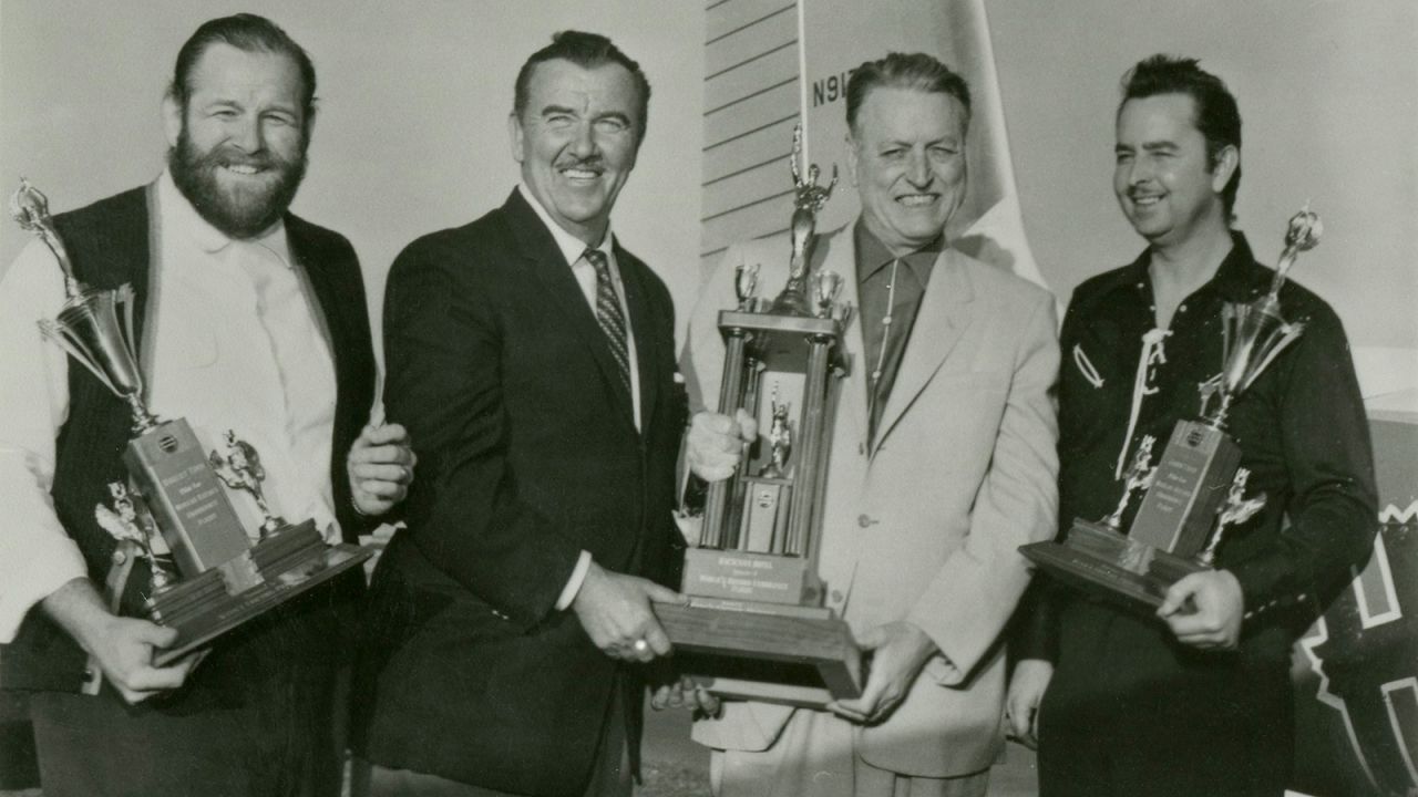 <strong>Record breakers: </strong>Holding their trophies for the world record endurance flight are Robert Timm, Preston Foster (actor and ground operations manager), Warren "Doc" Bailey (owner of the Hacienda) and John Cook. 