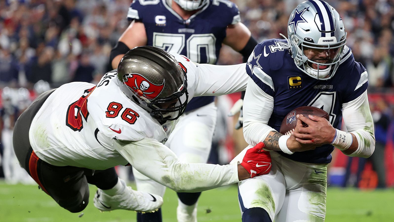 Dallas Cowboys quarterback Dak Prescott rushes the ball for a touchdown against Tampa Bay Buccaneers defensive end Akiem Hicks in the first half. Prescott accounted for five touchdowns -- one rushing and four passing -- in the Cowboys' 31-14 victory over the Bucs to set up a clash against the San Francisco 49ers in the next round of the playoffs.