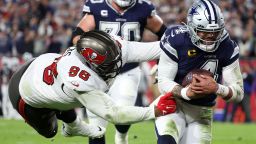Dallas Cowboys quarterback Dak Prescott (4) rushes the ball for a touchdown against the Tampa Bay Buccaneers defensive end Akiem Hicks (96) in the first half during the wild card game at Raymond James Stadium on January 16, 2023.